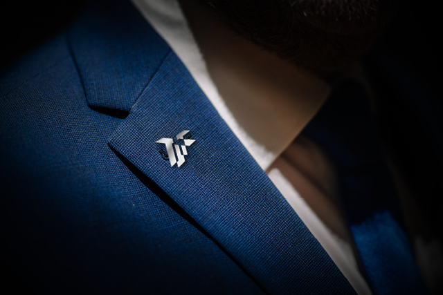man wearing pin on suit 