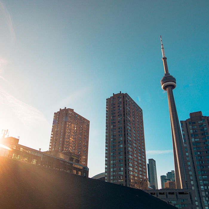 The CN Tower set amongst a blue skyline.