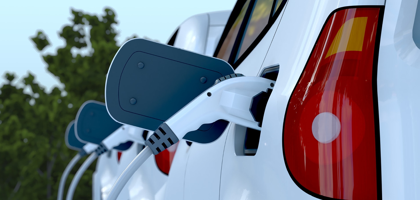 A row of electric cars being charged.