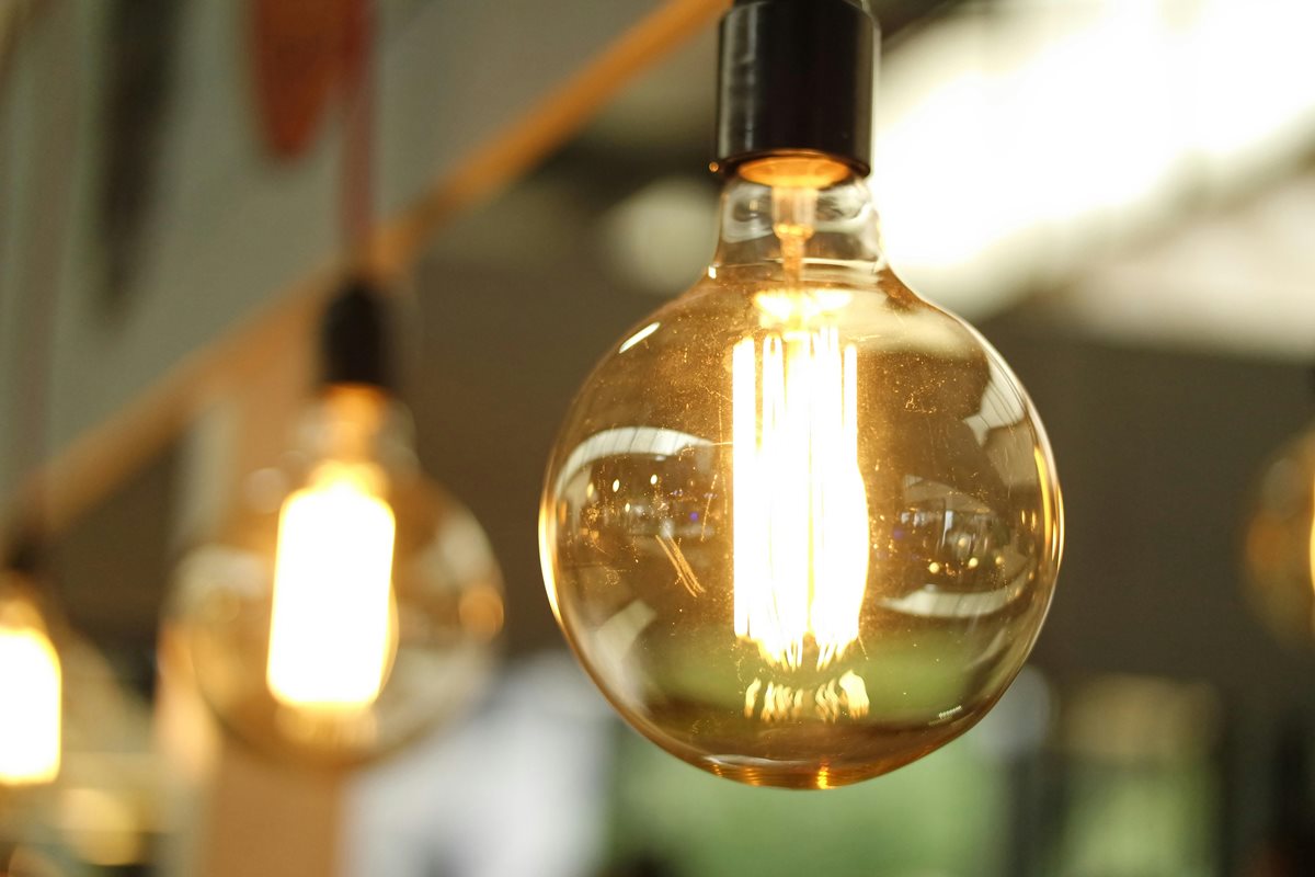 A bunch of hanging Edison bulbs, on a soft-focus background.