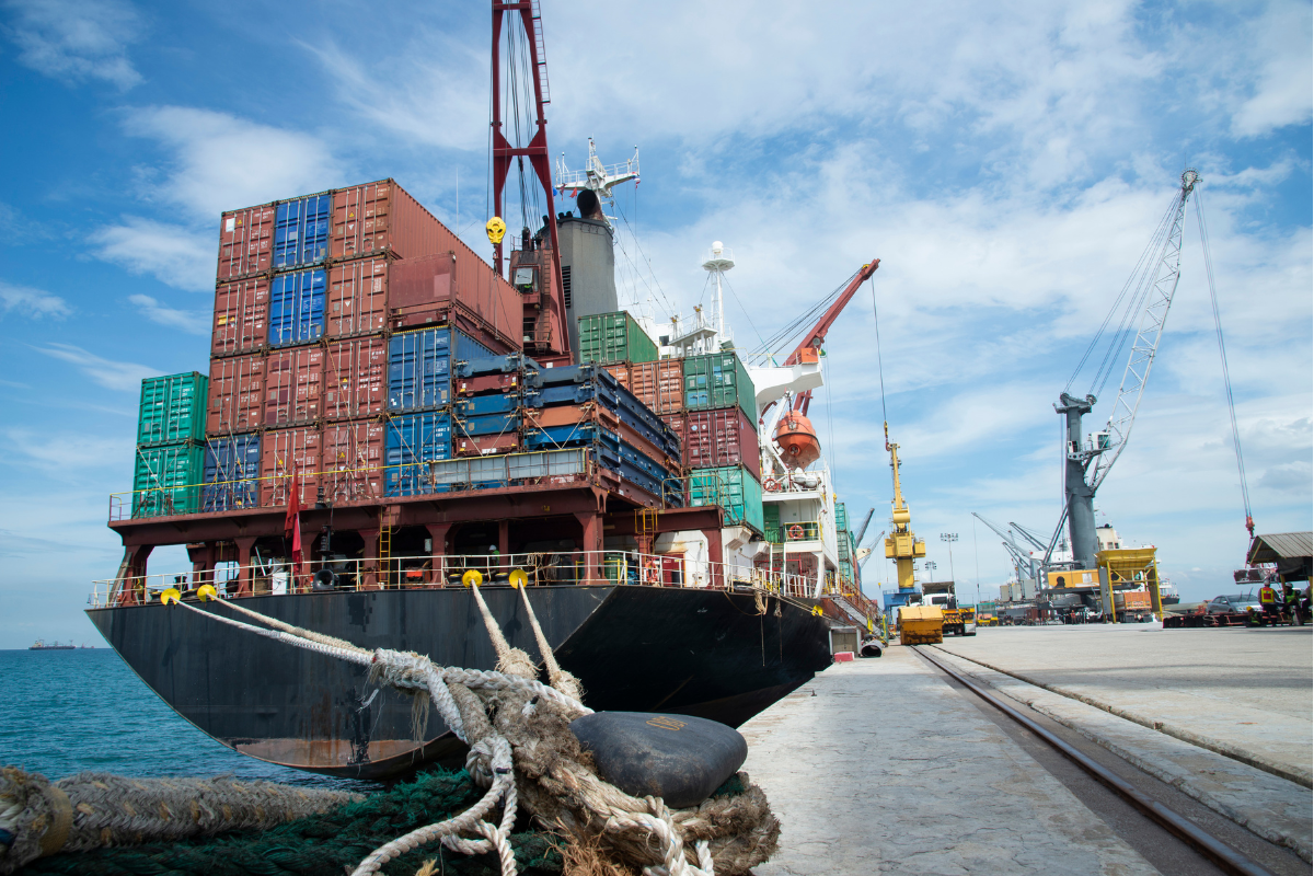 A shipping freighter with many cargo cans aboard.