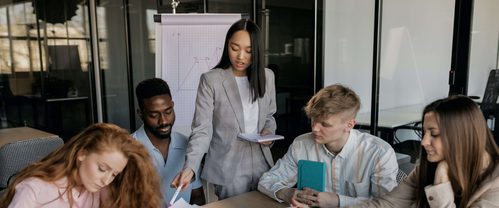 People in an office working together on a presentation.