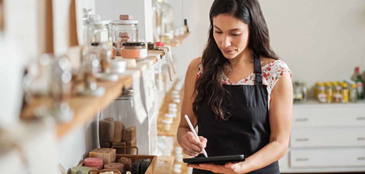 woman taking inventory in her shop