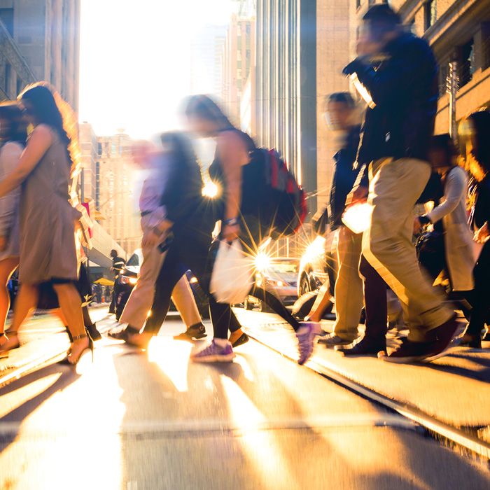 People crossing street at sunset