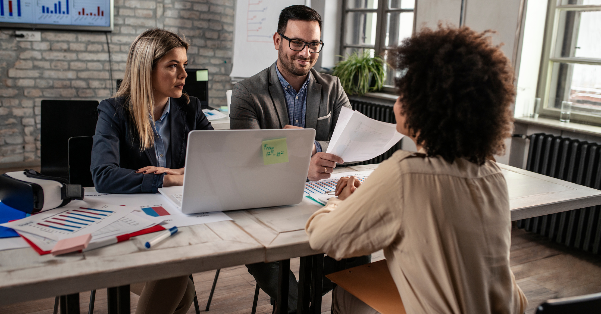 A group of people working together, looking at a presentation.